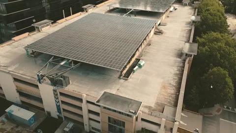 University parking structure hosting massive solar array captured descending Stock Footage 334640952