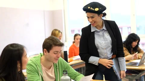 University professor guiding student's work in classroom Stock Footage 302818837