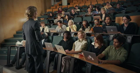University Professor Lecturing in Class Hall To Students Видео 326418736