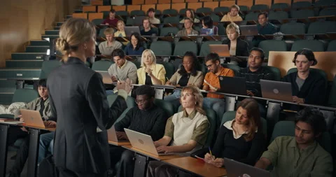 University Professor Lecturing in Class Hall To Students Видео 326419123
