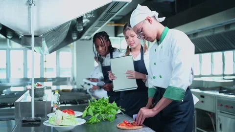 University professor is passing on the knowledge of cooking to students Stock Footage 255998680