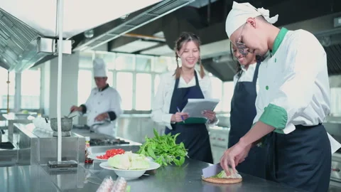 University professor is passing on the knowledge of cooking to students Stock Footage 255999027