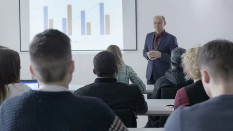 University student asking a question to professor in a lecture Stock Footage 69931201