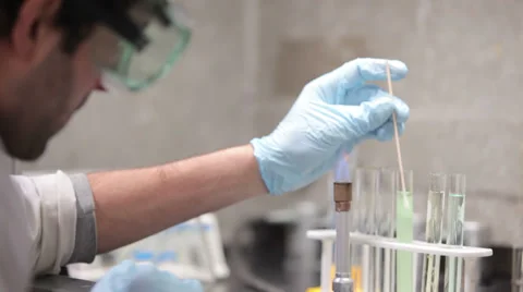 A university student conducts experiments during a chemistry lab class Video stock 33880872