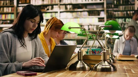 University student getting distracted by notification on phone while studying Stock Footage 336358950
