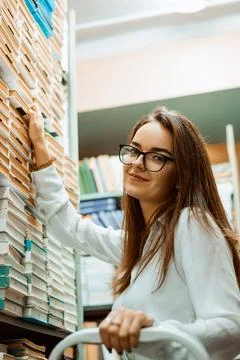 University student having practice working with books in the library Stock Photos