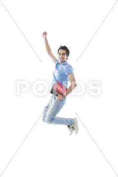 University student holding books and jumping Stock Photos