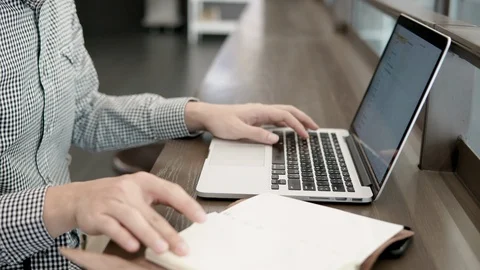 University student man using laptop computer and opening notebook Stock-Footage 91003354