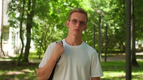 University student walking on campus. Man raking a walk to college. Young u.. Stock-Footage 339526461