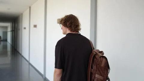 University student walks to class with backpack on campus Video stock 338277650
