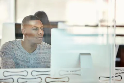 University student working at computer behind glass partition Stock Photos