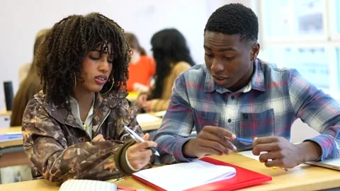 University students collaborating on project in classroom Stock Footage 302818888