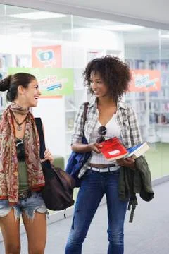 University students looking to each other in a library Stock Photos