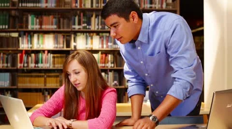University students studying in the library together Stock Footage 22384975