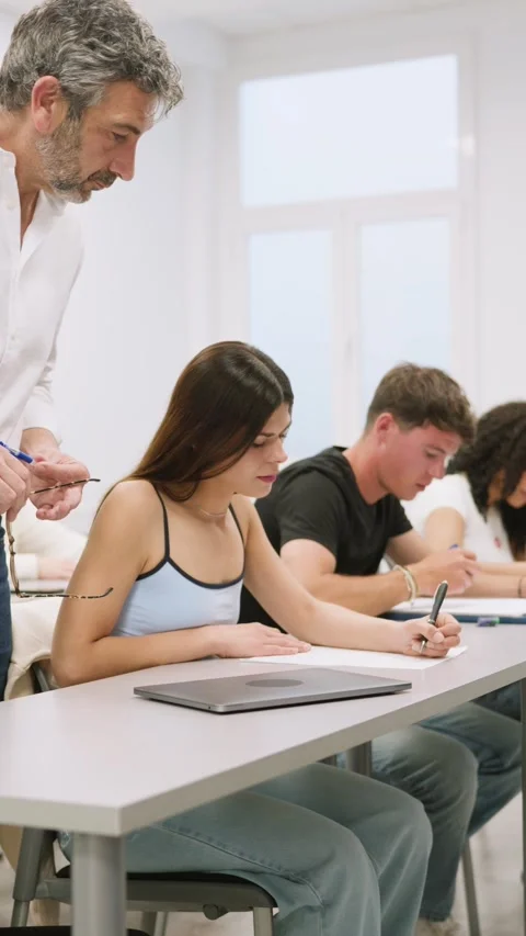 University students taking an exam in a classroom Stock Footage 343858671