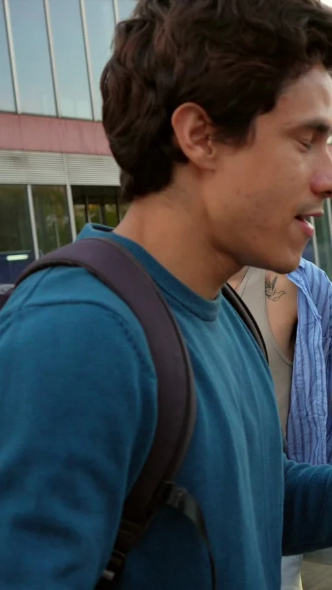 University students talking and laughing during an interview on campus Stock Footage 317849953