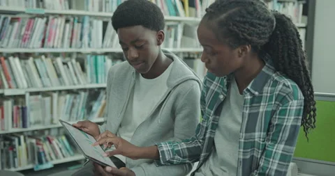 University Students using Digital Tablet in Library Stock Footage 202157602