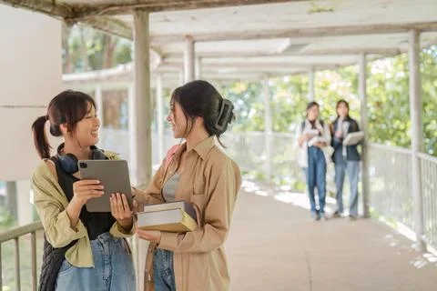 University students using a digital tablet while walking to next class Stock Photos