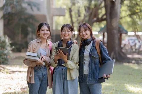 University students using a digital tablet while walking to next class Foto stock