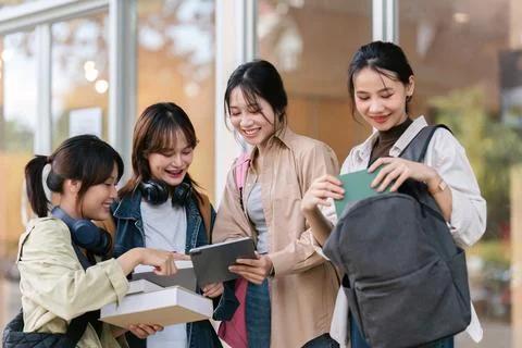 University students using a digital tablet while walking to next class Foto stock