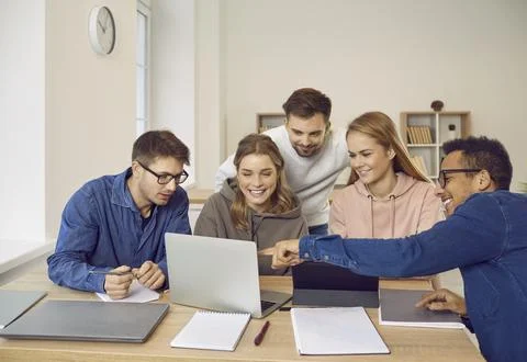 University students using a laptop computer while working on their group project Foto stock