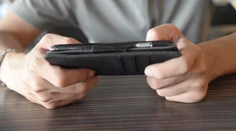 Unknown Asian male use smartphone with touch screen for play a game Stock Footage 63271853