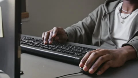 Unknown Black Male Software Developer Typing on Keyboard and Using Mouse Video stock 336709266