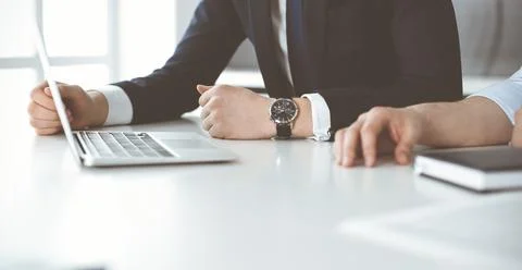 Unknown business people using laptop computer at the desk in modern office Stock Photos