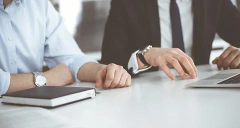 Unknown business people using laptop computer at the desk in modern office Stock Photos
