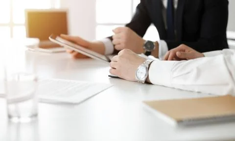 Unknown business people using tablet computer in sunny office. Businessman is Foto stock