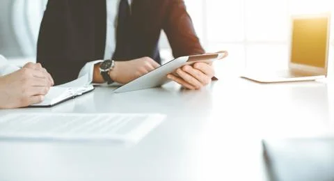 Unknown business people using tablet computer in modern office. Businessman or Foto stock