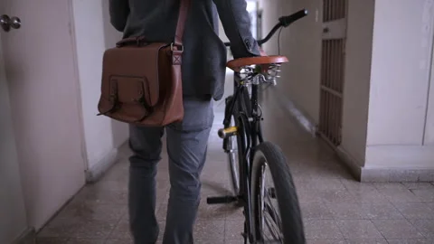 Unknown businessman with bicycle walking down hallway. Stock Footage 290162113