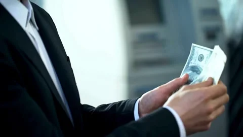 Unknown businessman counting dollars bills. Man calculating american banknotes Stock-Footage 336261287