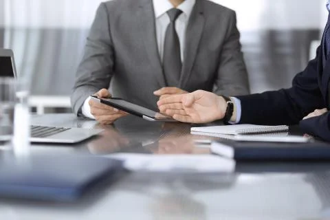 Unknown businessman using tablet computer and working together with his Stock Photos