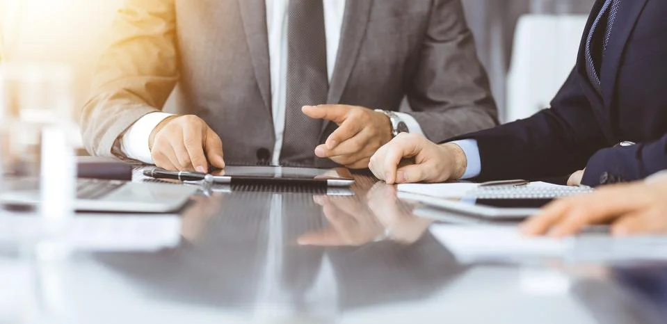Unknown businessman using tablet computer and working together with his Stock Photos