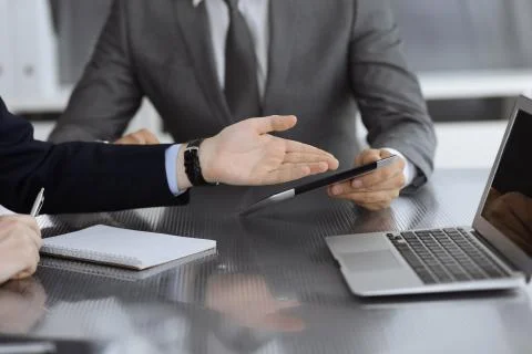 Unknown businessman using tablet computer and working together with his Stock Photos