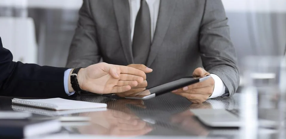 Unknown businessman using tablet computer and working together with his Stock Photos