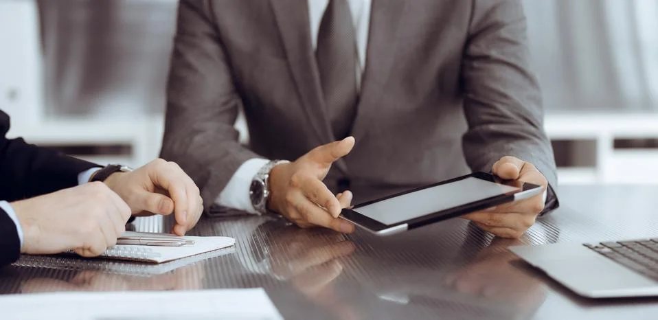 Unknown businessman using tablet computer and working together with his Stock Photos