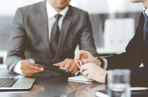 Unknown businessman using tablet computer and working together with his Stock Photos