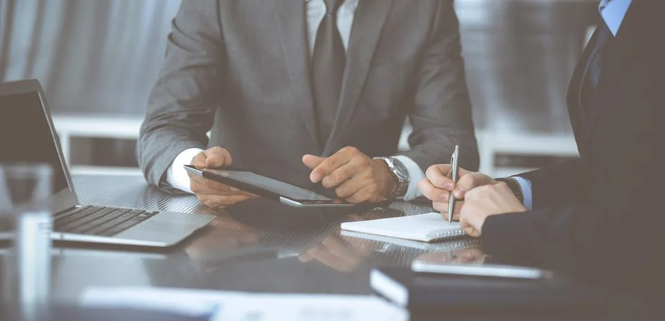 Unknown businessman using tablet computer and working together with his Stock Photos