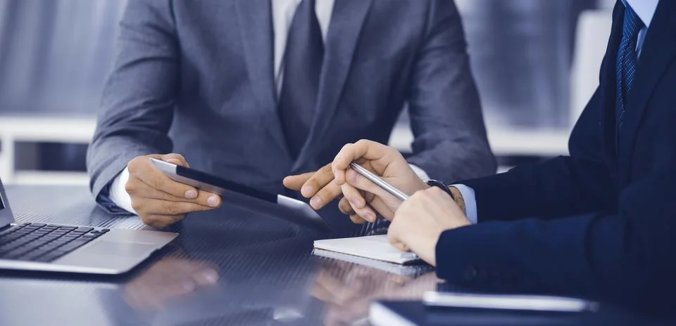 Unknown businessman using tablet computer and working together with his Stock Photos