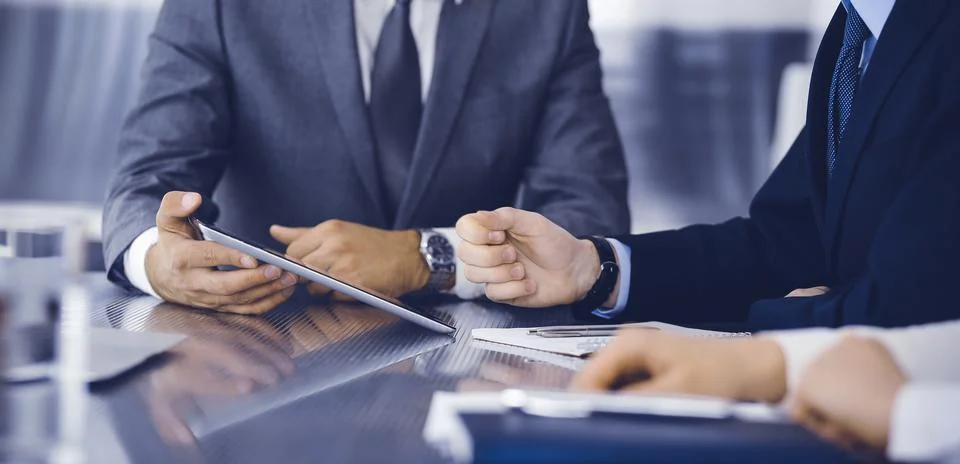 Unknown businessman using tablet computer and working together with his Stock Photos
