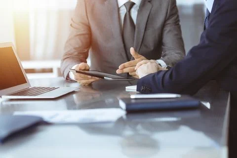 Unknown businessman using tablet computer and working together with his Stock Photos