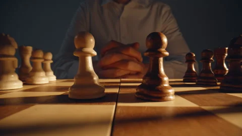 Unknown chess player sitting chessboard zoom on. Gamer pondering move thinking Stock Footage 332336656