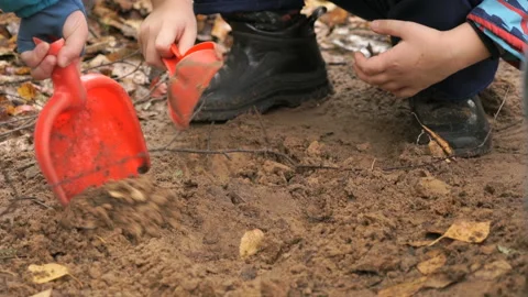 Unknown child playing with sand in sandbox Stock-Footage 86216927