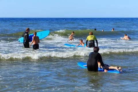 Unknown children resting and learning of surfing with professional instructors Stock Photos