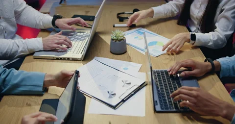 Unknown confident responsible men and women working together at workplace with Stock Footage 165288075
