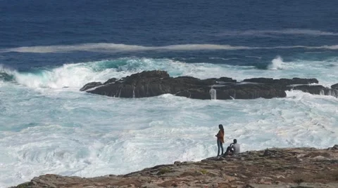 An unknown couple watching the waves off the coast of A Coruna Stock Footage 67325454