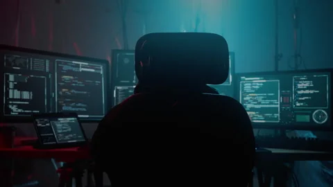 Unknown cyber thief writing virus code using computers Stock Footage 257381415