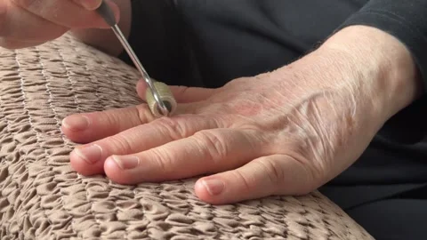 An unknown elderly woman makes herself a hand massage with her hand with a Stock Footage 300054960